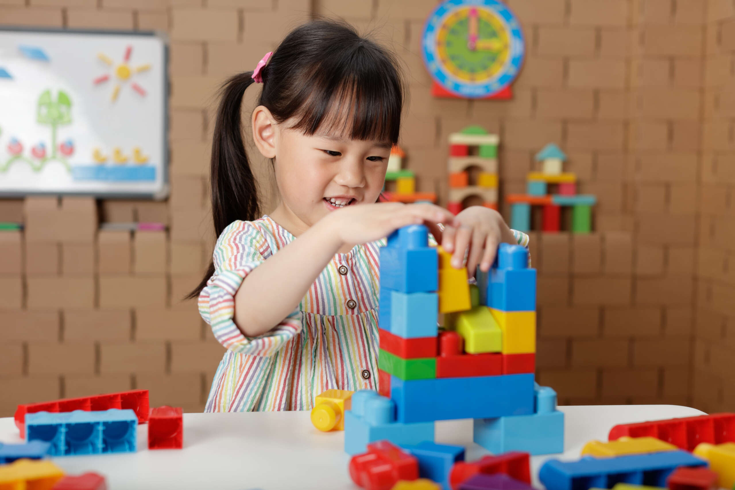 091a7409a1be7e191a2c9d91e9c52a14 (1) A girl engaged in play activity to enhance cognitive and perceptive skills.